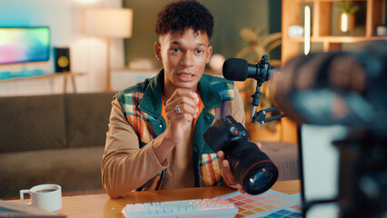 Poster - Content creator, camera and man live streaming for review, podcast or social media promotion. Filming, product or influencer show tech for advertising, photography or picture quality with mic at home