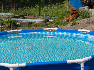 Poster - A blue pool with a teddy bear sitting on the edge
