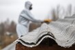 © leszekglasner - Worker in a special protective uniform removes old carcinogenic asbestos sheets from the roof