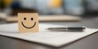 © Nice Seven - A smiley face on a sticky note sits next to a pen on a document, symbolizing positivity and productivity at work.