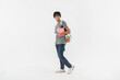 © InsideCreativeHouse - Full body side view young smiling happy man student wear casual clothes backpack bag hold books walking going isolated on white background. High school university college concept