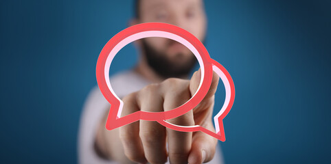 Image of a man interacting with digital speech bubbles, symbolizing communication, conversation, and connection.