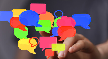 Aufkleber - Abstract image of colorful speech bubbles held in a hand, representing communication, conversation, and social media.