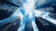 © Sanwa - Skyscrapers Reaching for the Sky - Low angle view of modern skyscrapers against a bright blue sky with fluffy clouds. Ambitious and successful concept