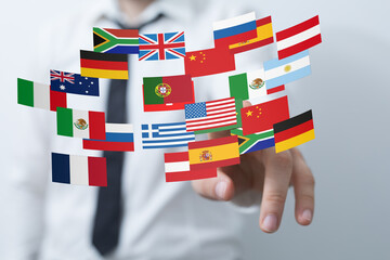 Aufkleber - Image of a businessman interacting with flags representing global reach and international business.