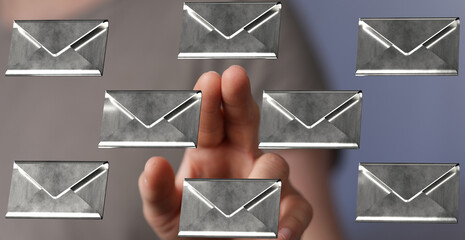 Hand interacting with digital mail icons, representing email management and communication.