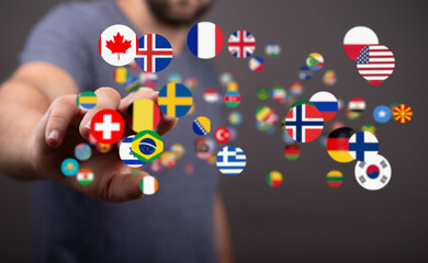 Aufkleber - Person's hand interacts with floating flags, symbolizing global reach, international communication, and world connection.