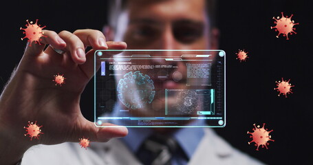 Poster - Image of coronavirus cells over male doctor holding clear tablet processing data about cell