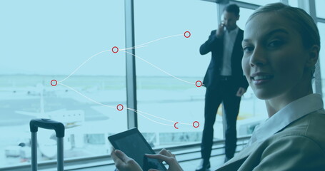 Poster - Image of connections over caucasian businesswoman at airport with laptop