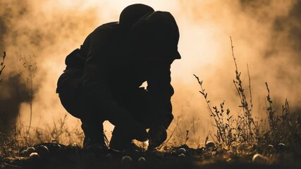 Poster - A person kneels down in a lush green grass field with a calm and serene atmosphere