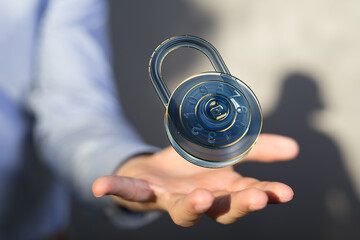 Poster - Image of a digital combination lock hovering above a hand, symbolizing data security and protection.