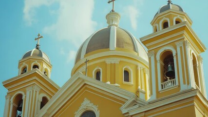 Poster - A large yellow building featuring a prominent cross on its rooftop, suitable for use in religious or cultural contexts