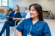 © unai - Smiling asian nurse attending medical conference in hospital meeting room