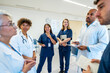 © unai - Medical team discussing patient cases during hospital meeting