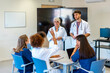 © unai - Medical team discussing patient cases during hospital meeting