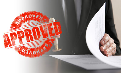 Fototapete - Man stamping document at desk and red stamp with word Approved. Banner design
