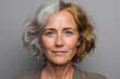 © Татьяна Яблокова - Front-facing portrait of elderly woman with half gray, half dyed light brown hair, calm expression, warm tones, natural light, realistic skin and hair texture.