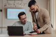 © Zamrznuti tonovi - Two businessmen collaborating on project using laptop and tablet in office