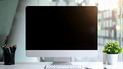 Leinwandbilder - Modern desktop computer with black screen display stands on clean white desk with peripherals and flowerpot near bright windows