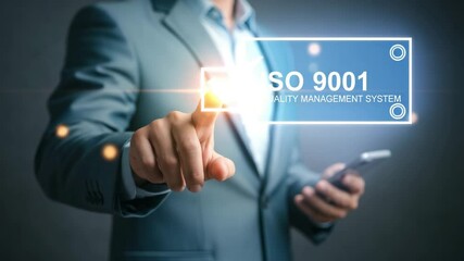 Poster - Man in suit pointing at iso 9001 quality management system with phone in hand against dark background