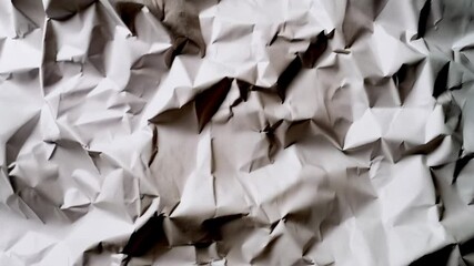 Poster - Abstract crumpled white paper background creates a dynamic and textured surface of light and shadow perfect for creative projects.