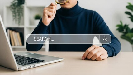 Poster - Person holding magnifying glass over search bar near laptop on a desk in a bright room