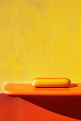 Aufkleber - Orange shelf with yellow object set against textured yellow wall