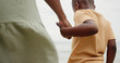 © AzeemudDeen/peopleimages.com - Holding hands, parent and child at beach on holiday with care, love and bonding in nature. People, kid and support with connection, outdoor and vacation for family with back, ocean and getaway by sea