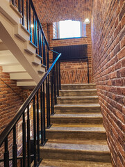 Aufkleber - Staircase in an Old Brick Building With Natural Light Illuminating the Steps and Walls