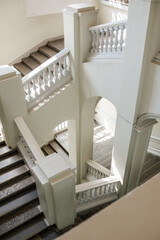 Leinwandbilder - Elegant White Staircase Design in a Modern Building With Natural Light Shining Through