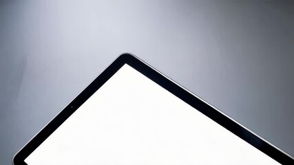Poster - Modern electronic tablet with a white screen on a sleek, plain, minimalist surface for presentation use