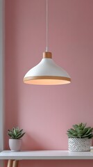 Aufkleber - A contemporary pendant lamp with a sleek design illuminates a small space. Below, two potted succulents add a touch of greenery against the soft pink backdrop, enhancing the decor's warmth