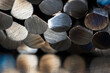 © salita2010 - Close-up of cut non-ferrous metal rods stacked together, showing texture and reflections, industrial macro detail