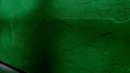 Poster - Textured deep green painted wall surface exhibiting subtle pattern and tonal variations in shade, perfect for backgrounds.