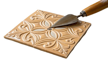 Poster - Trowel is lifting a beige ceramic tile with an embossed floral pattern, showcasing the tile's detailed design and craftsmanship against a transparent background