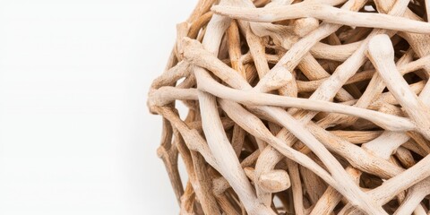 Poster - A close-up of an intricate decorative ball made from interwoven natural wooden sticks against a white background.