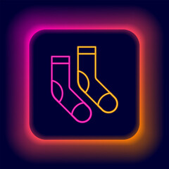 Poster - Glowing neon line Socks icon isolated on black background. Colorful outline concept. Vector