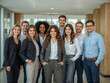 © STM Lab - Group of diverse business professionals standing together in a modern office space