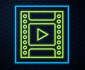 Poster - Glowing neon line Camera vintage film roll cartridge icon isolated on brick wall background. 35mm film canister. Filmstrip photographer equipment. Vector