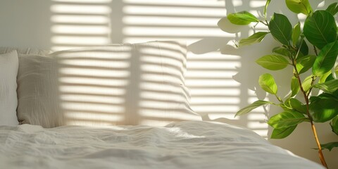Poster - Warm natural bedroom concept. Cozy bedroom scene with sunlight casting shadows on a bed and a green plant nearby.