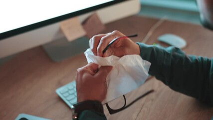 Poster - Cleaning, glasses and tissue with business man in office at night for deadline on company report. Information, reading and wipe with dirty eyewear of employee at desk in workplace for online research