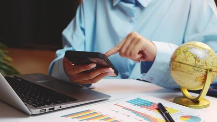 Poster - Young Professional Using Smartphone with Global Globe and Laptop in Modern Office Workspace Setting