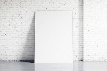 Poster - Blank white canvas leaning against textured white brick wall.