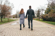 © fotofabrika - Couple walking hand in hand through a park on a cloudy day in autumn