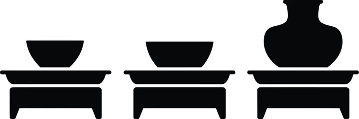 Poster - three black silhouette illustrations of bowls and a vase on stands against a white background space