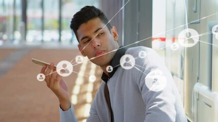 Man pressing phone to mouth on platform activating user-icons showing social network message