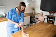© zinkevych - Young nurse cleaning the kitchen in the elderly woman house