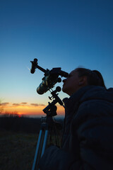 Wall Mural - amateur astronomer using telescope for watching stars, moon, planets and other celestial objects fro
