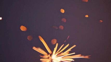 Poster - Golden sparks bursting from burning bengal light, generating festive energy against dark backdrop with glowing, shimmering luminescence representing holiday celebration and magical moment
