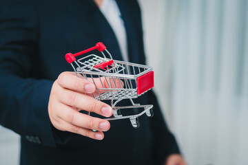 Poster - Business strategy handing over a shopping cart a modern retail environment